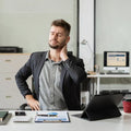 Male businessman is doing a stretchy posture due to sitting in the office for too long.